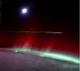 video from space shows green Auroras amid moonset