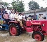 AP minister Kollu Ravindra drove tractor in flood hit areas in Vijayawada