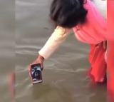 Woman Dips Phone In Sangam For Husband