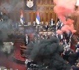 at least 3 serbian lawmakers injured as smoke bombs and flares thrown in parliament