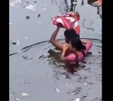Father becomes real life Bahubali to save baby in floods