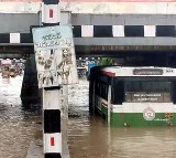 Warangal Floods RTC Bus Stuck Under Bridge Passengers Panic