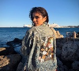After director Maruthi, actress Malavika Mohanan now sports outfit bearing 'The Raja Saab' poster in Greece
