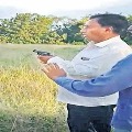 Ex minister Gutta Mohan Reddy warns officials with Gun