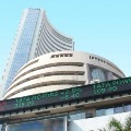 Sensex closes 879 points high