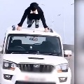 Man does push ups on roof of moving car in viral video