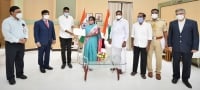 Governor Tamilisai presents laptop to a needy-student